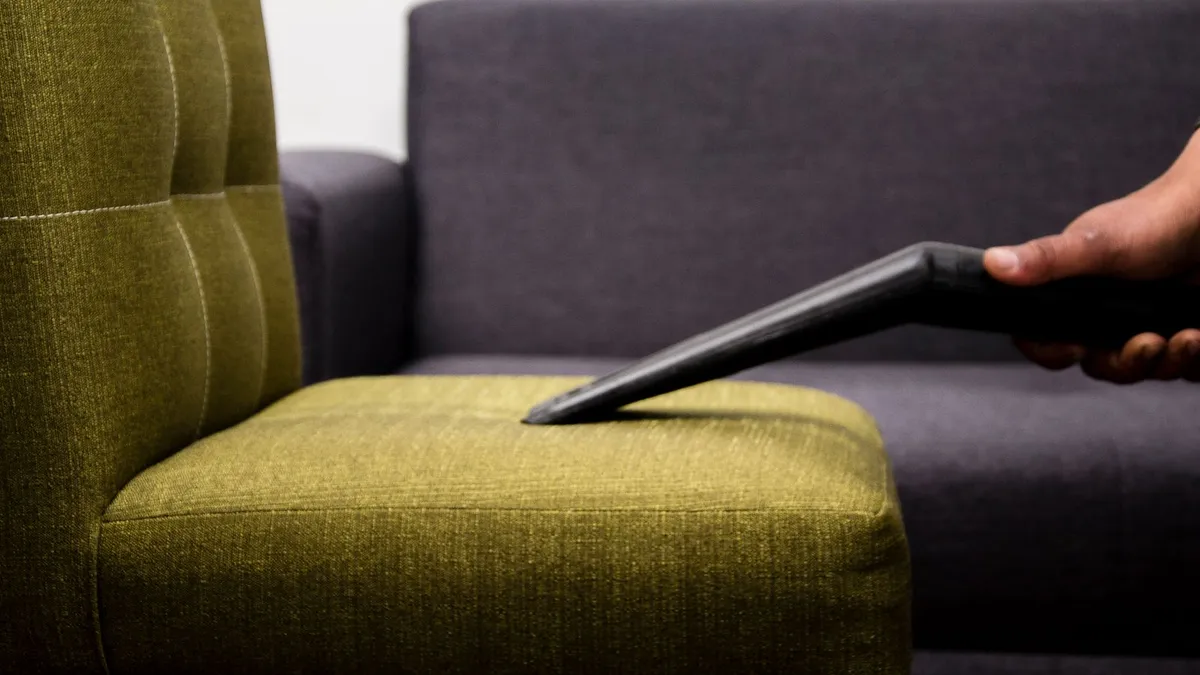 Upholstery on a sofa being professionally cleaned as part of the same three-step process